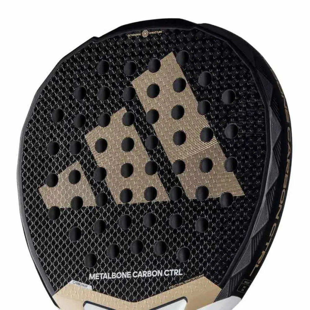 Raquete de padel Adidas Metalbone Carbon CTRL, com design preto e dourado, superfície texturizada em padrão hexagonal e furos simétricos, destacando o logotipo da Adidas em dourado no centro.